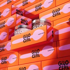 two jars of gelo are stacked on top of each other in front of orange boxes