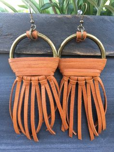 These earrings are handmade and perfect for fall style! The leather fringe is tan in color, and the hooks and hoops are a bronze metal. This pair is a larger pair measuring about an inch and a half width and a four and a half inch dangle. Ready to ship! Brown Tassel Earrings For Festivals, Adjustable Brown Bohemian Tassel Earrings, Bohemian Brown Fringe Earrings, Handmade Brown Tassel Earrings, Brown Fringe Tassel Earrings For Festivals, Brown Dangle Earrings With Tassels, Brown Fringe Tassel Dangle Earrings, Brown Fringe Dangle Tassel Earrings, Brown Dangle Tassel Earrings With Fringe