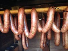 several sausages hanging from a wooden rack