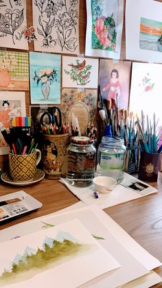 art supplies are sitting on a desk with pictures and pencils