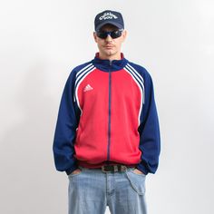 Vintage 90's Adidas tracksuit top with a front zip - in red-blue with white stripes - embroidered logo on the chest and on the back - 2 outer pockets with zipper closure - material: polyester Size from the label: USA XL, GB 46/48, D 9, F 198 MEASUREMENTS width from armpit to armpit: 27.5 inches (70 cm) length: 29 inches (74 cm) sleeve length from the neck: 32 inches (82 cm) The model is 6'1" (186 cm), measures 41-35-39 (104-88-100 cm) and typically wears clothing in size L CONDITION - 8/10 - Gre Sports Tracksuit With Three Stripes And Long Sleeves, Casual Track Jacket With Contrast Stripes For Sports, Three Stripes Track Jacket For Sports Events, Red Sportswear Track Jacket For Sports Events, Throwback Sports Track Jacket, Red Track Jacket For Sports Events, Sporty Red Track Jacket For Athletic Season, Red Sporty Track Jacket For Sports Season, Casual Red Track Jacket For Sports Events