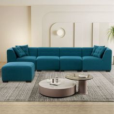 a modern living room with blue couches and round coffee table in the center area