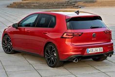 the rear end of a red volkswagen car