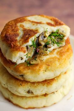 some food is stacked on top of each other with the words mushroom stuffed potato cakes