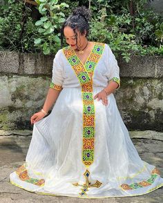 Embrace the beauty of simplicity with our Yellow Design Simple Modern Habesha Dress, handwoven using Menen fabric. The understated elegance of this dress lies in its modern cut and vibrant yellow design. Crafted with the utmost care and attention to detail, this Habesha dress captures the essence of Ethiopian fashion. The lightweight cotton material and intricate threadwork make it comfortable to wear, allowing you to radiate confidence and grace. Add a contemporary twist to your wardrobe with t Habesha Dress Modern, Modern Habesha Dress, Ethiopian Fashion, Habesha Dress, Ethiopian Dress, Habesha Kemis, Beauty Of Simplicity, Radiate Confidence, Yellow Design