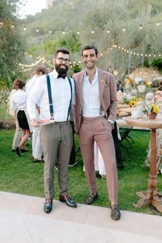 two men standing next to each other in formal attire