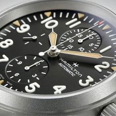 Typically associated with racing and other sports, chronographs can also be valuable for coordination in the field, which is why you'll find one on this Khaki Field watch from Hamilton. It draws on the company's military heritage with a straightforward 44mm sandblasted stainless steel case and a black dial with raised SuperLuminova-coated numerals and three sub-dials. Two pushers join a screw-down crown on the watch's right side, and it's finished with a comfortable calf leather bund strap. Classic Outdoor Chronograph Watch With Tachymeter, Silver Chronograph Watch For Outdoor, Silver Chronograph Watch With Chronometer For Outdoor, Hamilton Khaki Field, Hamilton Khaki, Chrono Watches, Field Watches, The Field, Stainless Steel Case