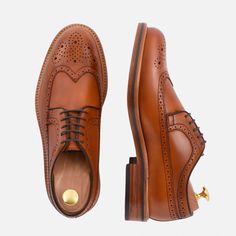 Stylish and unique. If you love the distinct look you can only get from a brogued shoe, the Royce Longwings are for you. The dramatic toe-cap swooping all the way back to the heel makes a stylish statement. Longwings pair perfectly with traditionally casual suit styles along with your favorite jeans, chinos and dress pants. Classic Brogue Dress Shoes For Galas, Classic Brogue Lace-up Shoes For Galas, Luxury Goodyear Welted Wingtip Derby, Masculine Fitted Wingtip Oxfords, Fitted Masculine Wingtip Oxfords, Masculine Wingtip Leather Shoes With Brogue Detailing, Classic Wingtip Dress Shoes With Leather Sole, Masculine Wingtip Leather Shoes With Goodyear Welt, Brogue Oxfords For Galas With Snip Toe