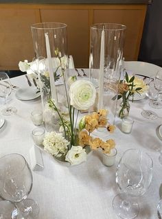 the table is set with flowers and candles