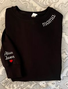 "Welcome to our shop! Stay cozy and stylish with our Mama Embroidered Sweatshirt, a must-have for all proud mothers. This custom sweatshirt features the names of your kids, making it a unique and sentimental piece that celebrates the beautiful journey of motherhood.  Whether it's a pregnancy reveal or a special Mother's Day gift, this sweatshirt is sure to warm the heart of any new mom and become a cherished part of her wardrobe. ALL ITEMS ARE SOLD SEPARATELY How to order: -Select the shirt styl Black Long Sleeve Sweatshirt With Letter Embroidery, Long Sleeve Fleece Top With Letter Embroidery, Fleece Top With Letter Embroidery And Long Sleeves, Cozy Fit Black Cotton Sweatshirt, Black Sweater With Letter Embroidery For Winter, Black Cotton Sweater With Letter Embroidery, Cotton Long Sleeve Hoodie With Embroidered Text, Cotton Long Sleeve Sweatshirt With Letter Embroidery, Cotton Hoodie With Embroidered Graphics