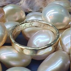 a close up of a ring surrounded by pearls