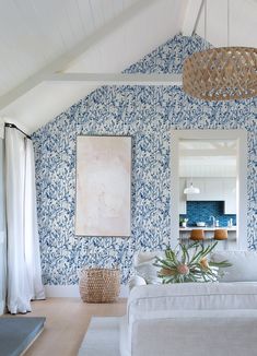 a living room with blue and white wallpaper