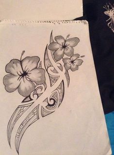 a tattoo design with flowers on the side of a white paper bag next to a blue towel