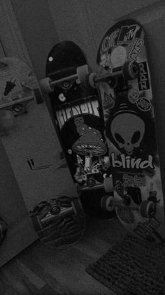 the skateboard is upside down on the floor in the room with other skateboards