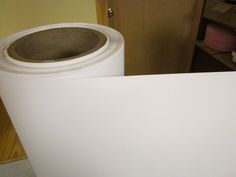 two rolls of white paper sitting on top of each other in front of a door