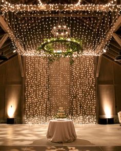 an indoor wedding venue decorated with fairy lights