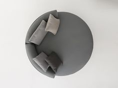 a round table with four pillows on it