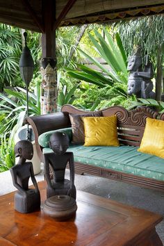 a wooden bench sitting next to a green couch on top of a wooden coffee table