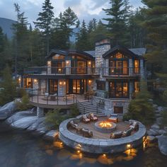 a large house with a fire pit in the middle of it and lots of windows