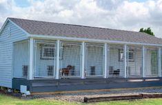 a small white building with several windows on the front and side of it's roof