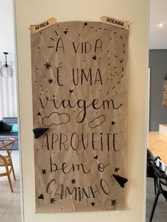 a brown paper bag with writing on it hanging from the side of a kitchen wall