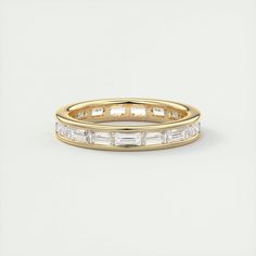 a yellow gold wedding band with baguettes on the side and sides in white diamonds