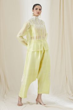 Yellow shirt with tassel detail and floral embroidery. Paired with crop top and embroidered, drop crotch pant.
Component: 3
Pattern: Embroidered
Type Of Work: Floral,Paisley
Neckline: High Neck
Sleeve Type: Sheer
Color: Yellow
Other Details: 
Front buttons
Tassel overlay
Occasion: Party - Aza Fashions Anamika Khanna, Drop Crotch Pants, Sheer Shirt, Yellow Shirts, Pant Set, Shirt And Pants, Set For Women, Aza Fashion, Floral Embroidery