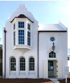 a large white building with arched windows on the front