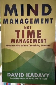 a book about mind management is being held up