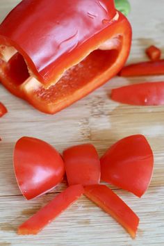 sliced up tomatoes on a cutting board with one cut in half