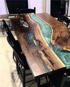 the table is made out of wood and has a river running through it with blue water