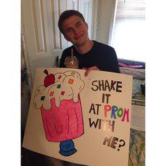 a man holding up a sign that says shake it at prom with me and an ice cream sundae