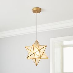 a star shaped light hanging from the ceiling