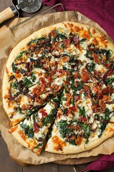 a pizza sitting on top of a wooden cutting board