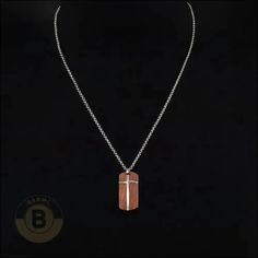 The moment you put on this special necklace, a subtle yet distinctive energy takes hold. The smooth rosewood crucifix has an almost mystical aura about it that makes you feel grounded and connected. As the durable steel links rest against your chest, you’ll stand a little taller. There’s something quietly powerful in a style that blends modern and organic. Specifications: Materials: Stainless Steel with Rosewood PendantFinish: PolishedLength: 22" | 56cmPendant Size: 1.496" | 3.8cm X 0.709" | 1.8cmWeight: 24g When it comes to men’s necklaces, stainless steel brings strength, shine, and street cred to the table. Stainless Steel necklaces interlock metal rings, discs, or beads in badass textures perfect for the modern man. From chunky Cuban links with an edgy urban appeal to low-key beads tha Spiritual Stainless Steel Cross Pendant Necklaces, Brown Crucifix Jewelry Gift, Brown Crucifix Jewelry For Gifts, Spiritual Crucifix Necklace With Silver Chain, Spiritual Silver Chain Necklace With Cross Pendant, Spiritual Necklace With Silver Chain And Cross Pendant, Spiritual Cross Necklace With Silver Chain For Gift, Brown Crucifix Necklace In Spiritual Style, Brown Spiritual Necklace With Cross Pendant