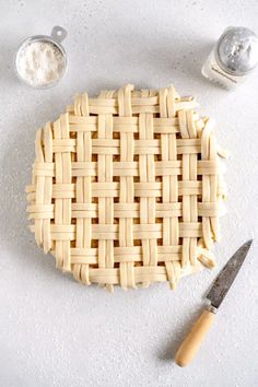 a pie crust on a table next to other baking supplies