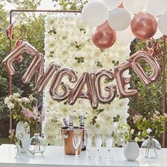 a table topped with balloons and wine glasses