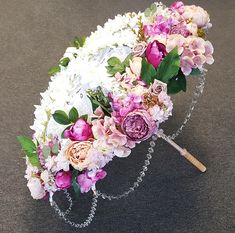 an umbrella decorated with flowers and greenery