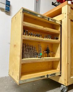 a wooden cabinet with lots of tools in it