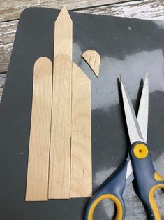 scissors and wooden planks cut out to look like an angel