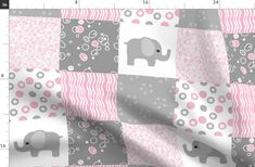 a pink and gray patchwork with an elephant on it's side, in the middle