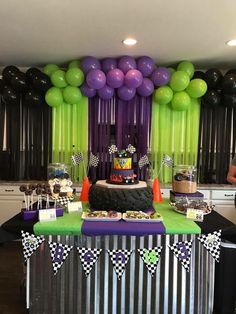 a birthday party with purple, green and black balloons