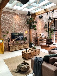 a living room filled with furniture and a brick wall