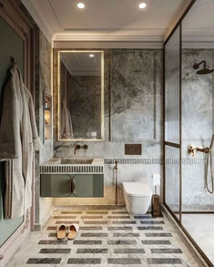 a bathroom with marble flooring and walls