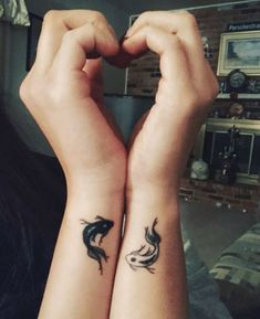 two people with matching tattoos on their arms