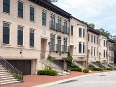 several brick townhouses with balconies and stairs