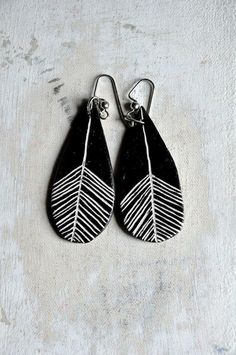 two black and white leaf shaped earrings