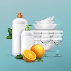 an image of bottles and glasses with oranges next to them on a blue background