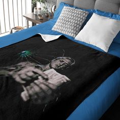 a bed with blue sheets and pillows on it