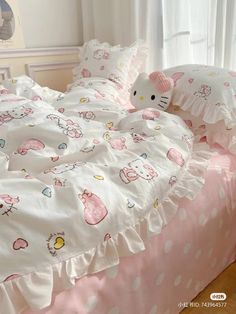 a hello kitty bed set with pink and white polka dots on the bedspread